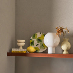 vase kudos next to other pots on a shelf