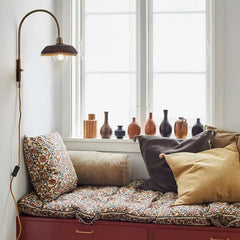 velvet bolster cushion in dusty green by Madam Stoltz in setting