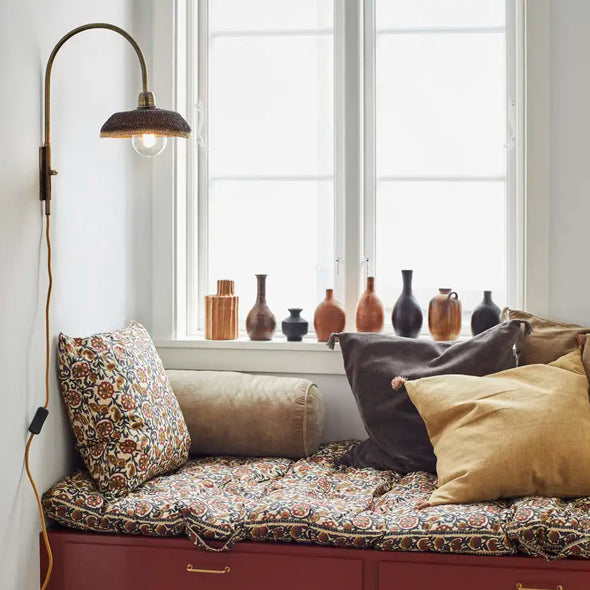 velvet bolster cushion in dusty green by Madam Stoltz in setting